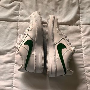 White air forces with green painted Nike logo